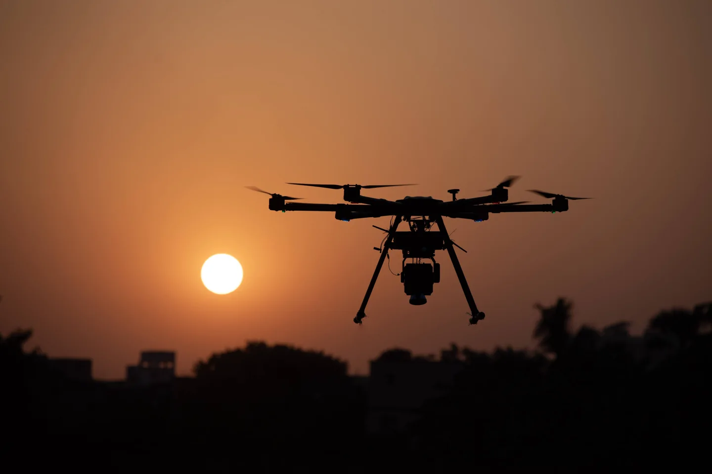 Drone silhouetted against the evening sky